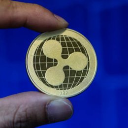 XRP Tests $1 Support As Long Liquidations Surge Inside Multi-Month Wedge